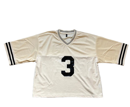 Cream sports jersey with number 3 on front in black